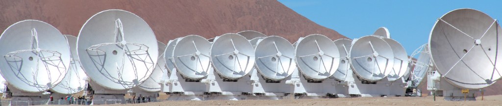 The silver antennas of the Atacama Large Millimetre/Submillimetre Array in Chile (a desert background)